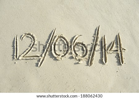 World Cup kick-off date message handwritten in sand Brazil