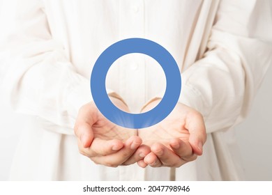 World diabetes day awareness concept. Doctor hands holding blue circle of universal symbol for diabetes. Support for the fight against diabetes.