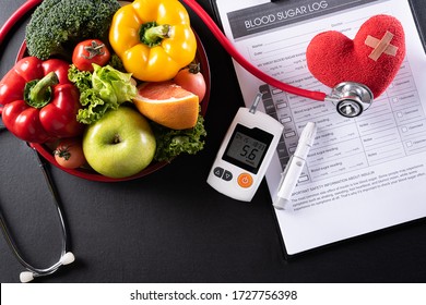 World Diabetes Day And Healthcare Concept. Patient's Blood Sugar Control, Diabetic Measurement, And Healthy Food Eating Nutrition With Red Heart On Black Background.