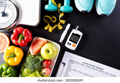 World diabetes day, Healthcare and medical concept. Healthy food including fresh fruits, vegetables, weight scale, sports shoes, measure tape and diabetic measurement set on black background.