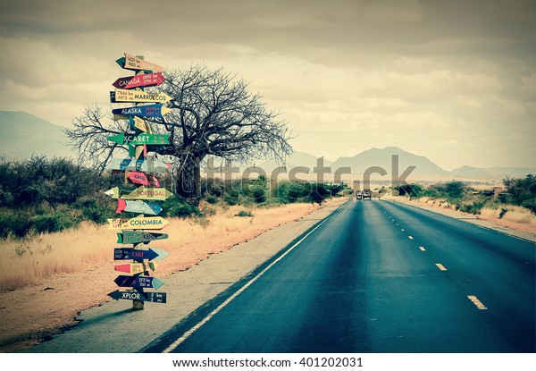 World directions signpost with distance to many\
different countries