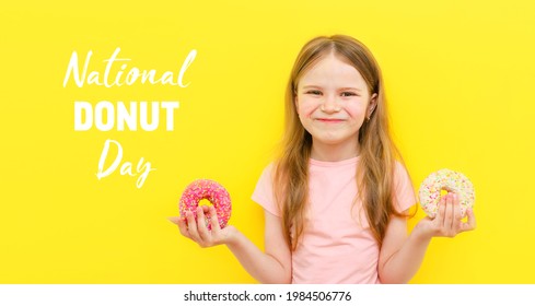 World Donut Day Or No Diet Day. A Little Girl Holding Donuts And Smiling, Holding On A Yellow Background. The Concept. Kids And Doughnuts, Sweets.