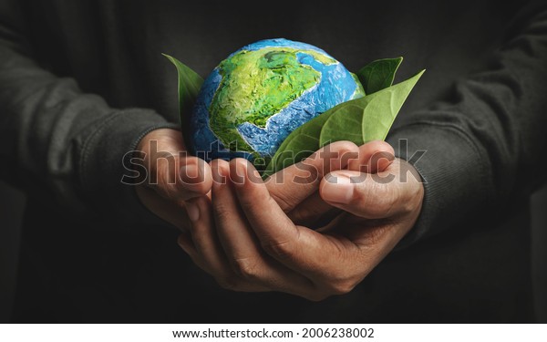 World Earth Day Concept. Green Energy, ESG,\
Environmental, social and corporate governance. Renewable and\
Sustainable Resources. Environmental and Ecology Care. Hand\
Embracing Green Leaf and\
Globe