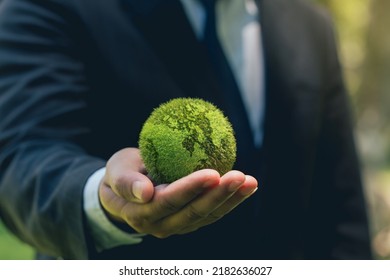 World Earth Day. ESG concept of environmental, social, and governance.Green Energy, Renewable and Sustainable Resources. Environmental and Ecology Care. Business Hand Holding Green  Globe.  - Shutterstock ID 2182636027