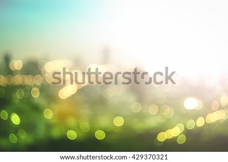 World environment day concept: Abstract blur colorful bokeh city lights over green nature autumn sunrise background