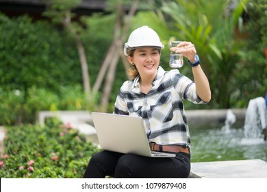 World Environment Day Concept ,Thai Asian Female Engineering Working With A Tablet Laptop At Sewage Treatment Plant, Engineer Controlling The Quality Of Water , Aerated Activated Sludge Tank 