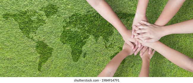 World environment day with global community teamwork, CSR and ESG environmental energy saving collaboration of young children hands stack together on green background for sustainable development goal - Shutterstock ID 1984914791