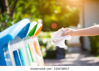 World Environment Day, June 5. Woman hand holding and putting issue paper waste into garbage trash. - Shutterstock ID 1106748917
