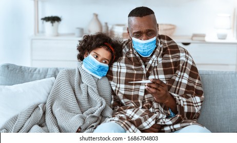 World Epidemic Concept. Mature African American Man And His Grandchild Wearing Masks And Suffering From Virus At Home