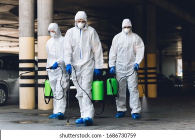 World epidemic. Workers in coronavirus suits cleaning streets with chemicals disinfection, copy space - Shutterstock ID 1686730759