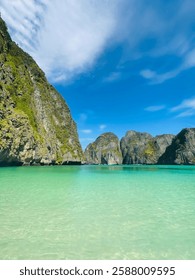 World famous Maya Bay, located in Ko Phi Phi Le, known for its white sandy beach, limestone cliffs, vibrant coral reefs, and bright turquoise water; featured in 