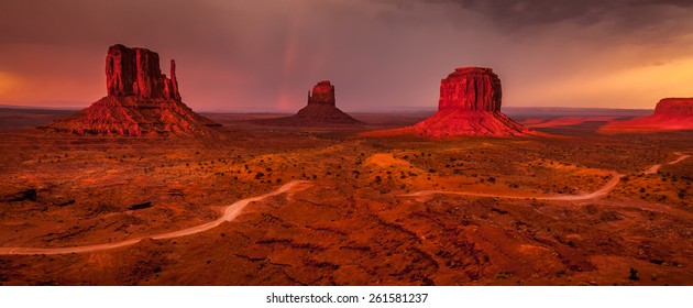 World famous Monument Valley mesas with a colorful sunset before the storm