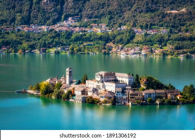 The world famous Orta San Giulio island, in the Orta Lake (piedmont, Northern Italy) seen from the top of Sacro Monte di Orta. UNESCO World Heritage Site, it is home to a convent of cloistered nuns.