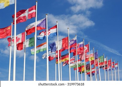 World Flags Blowing In The Wind On The Cloudy Sky Background