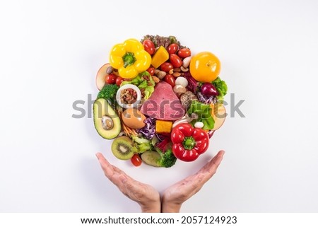 World food day, vegetarian day, Vegan day concept. Top view of woman hand covering fresh vegetables, fruit on white paper background.