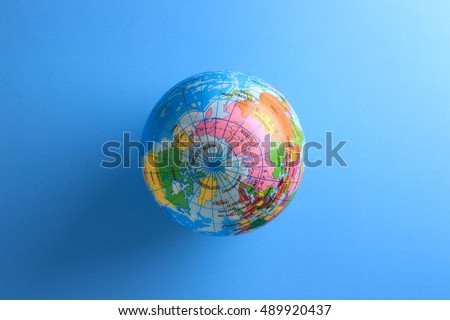 world globe ball on blue paper background 
