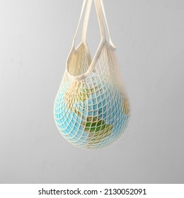 World globe in crochet bag, floating in air on light gray background. Eco-friendly life in the style of zero waste. Earth day, save the planet. - Shutterstock ID 2130052091