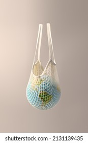 World Globe In Crochet Bag, Floating In Air On Beige Background. Eco-friendly Life In The Style Of Zero Waste. Earth Day, Save The Planet.