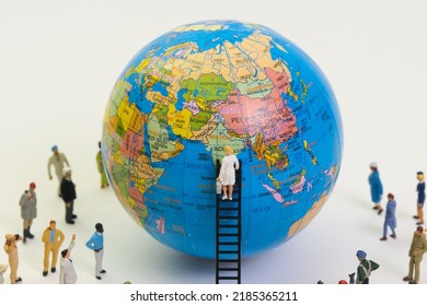 World Globe, A Doctor On A Ladder Examines The Earth , Many People Are Watching, Top View, White Background