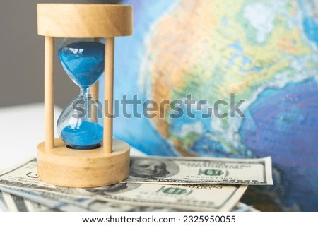 World globe with laptop and hourglass. Online business and globalisation theme