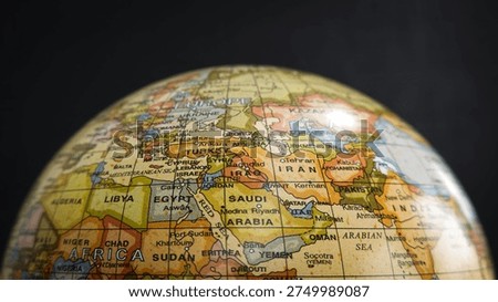 World globe map showing Middle East and Africa region. Close-up of a vintage globe map highlighting the Middle East and Africa region including Saudi Arabia, Iran, Egypt, and surrounding countries. Concept of global geography, education, travel, and international connections.