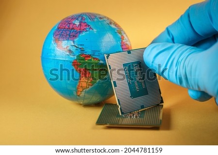 World globe and microprocessors against an orange background