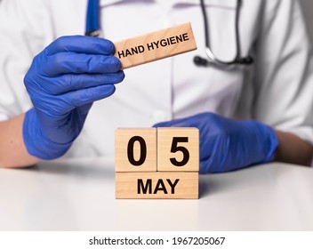 World Hand Hygiene Day Concept. Doctor Hands In Gloves With Wooden Calendar Of 5 May.