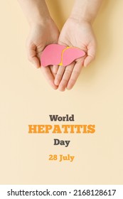 World hepatitis day. Adult hands holding liver on beige background. Awareness of prevention and treatment viral hepatitis. Liver cancer. World cancer day. Vertically Photo
