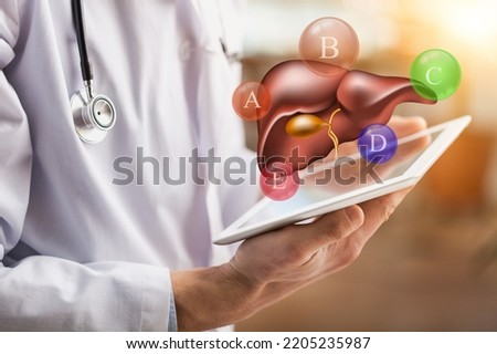 World hepatitis day concept. Doctor hands holding liver with virus symbol for diagnosis types of viral hepatitis or cancer. Awareness of prevention and treatment viral hepatitis.