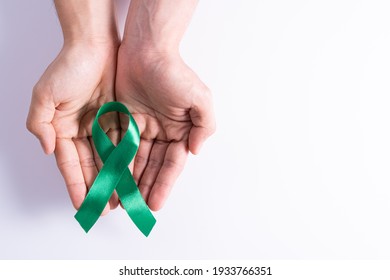 World Kidney Day, Hands Holding Green Ribbon Awareness Of Kidney Disease Isolated White Background.