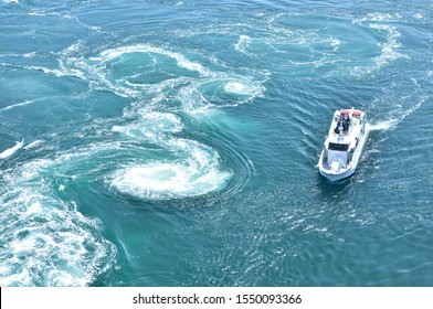 The world largest whirlpools in Naruto Channel and a sightseeing boat.