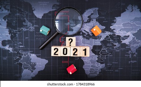 World Map With 2021 And Question Mark Wooden Blocks. Concept Of Forecasting Future Housing Market Trends, Is It Time To Buy Or Sale House Due To Impact Of Economic Recession From Coronavirus Crisis