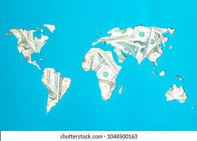 World map. Continents are laid out of dollars. Capitalism, consumer society concept