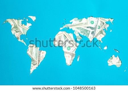 World map. Continents are laid out of dollars. Capitalism, consumer society concept