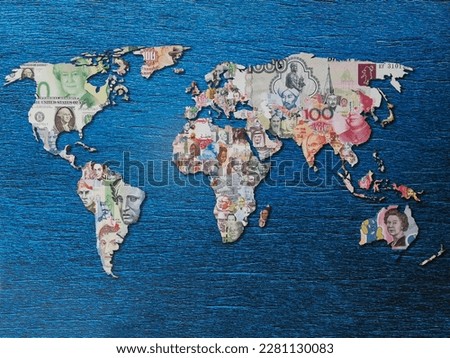 World map with continents made from money of different countries on blue background