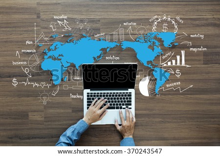 World map with creative thinking drawing charts and graphs business success strategy plan ideas,  With Man hand working on laptop computer keyboard with blank screen monitor, Top View