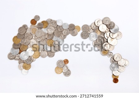 World map design made from assorted coins placed on a flat surface showing different currencies from various countries