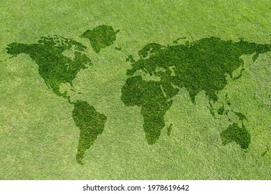 World map on green grass lawn background for global eco-friendly environment, ecological and environmental saving, earth day, and go green backdrop concept 
