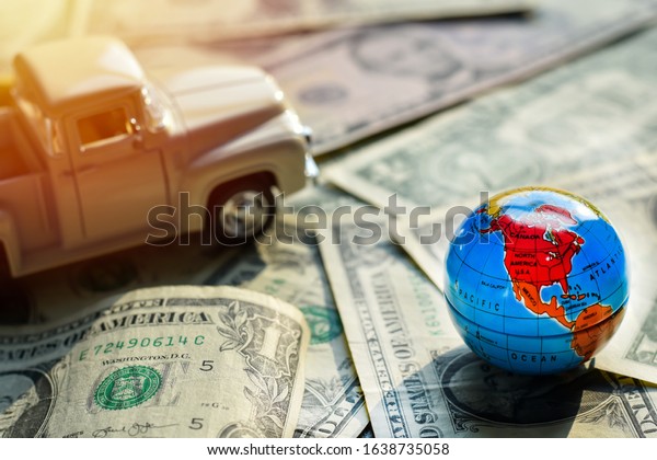 World map on money dollars, Concept\
investments for tourism has model car is\
backdrop.