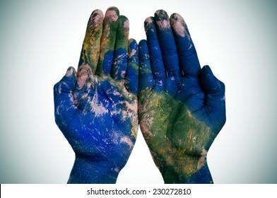 a world map in open man hands (Earth map furnished by NASA) - Shutterstock ID 230272810