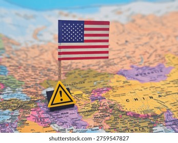 World map close‑up with US flag and WARNING sign near Iran, symbolizing US–Iran oil dispute, Strait of Hormuz crisis, war tension and global energy instability in Asia region.