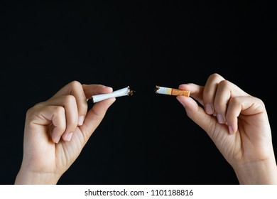 World No Tobacco Day, May 31. STOP Smoking. Close Up Woman Hand Breaking, Crushing Or Destroying Cigarettes On Black Background.