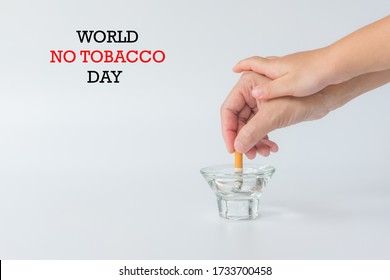 World No Tobacco Day, May 31. Stop Smoking.,Hand of father holding cigarettes, Hand of kid breaking hand of father before smoking cigarette, copy space.