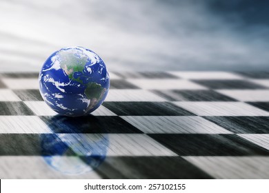 world on a chessboard isolated on blue sky background. Elements of this image furnished by NASA