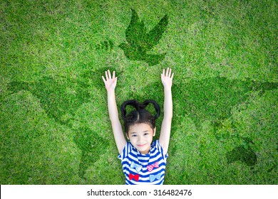 World Peace Day And International Day Of Peace Concept With Peaceful Mind Kid Resting In Clean Natural Environment On Eco Friendly Green Lawn World Map And Dove 