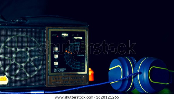 World Radio Day. Radio and headset on table,
with black background