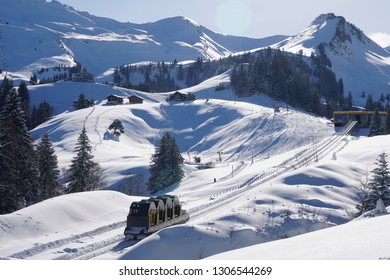 The world record breaking Stoosbahn mountain railway ascends to Stoos ski resort and village through spectacular scenery, deep snow and ski runs.