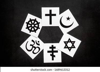 World religions concept. Christianity, Catholicism, Buddhism, Judaism, Islam symbols on black background top view