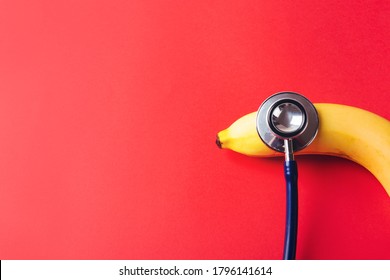 World Sexual Health Or Aids Day, Top View Flat Lay Of Doctor Stethoscope And Yellow Banana, Studio Shot Isolated On A Pink Background, Safe Sex And Reproductive Health Concept