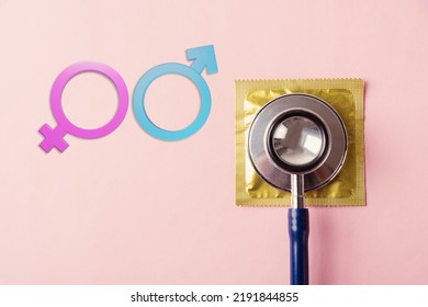 World Sexual Health Or Aids Day, Top View Flat Lay Medical Equipment, Condom In Pack, Doctor Stethoscope And Male And Female Gender Signs, Isolated On A Pink Background, Safe Sex Reproductive Health